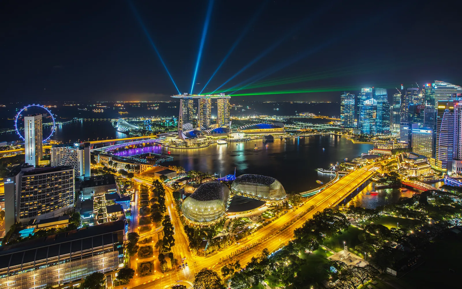 Singapore from above at night, the bay and city lit up
