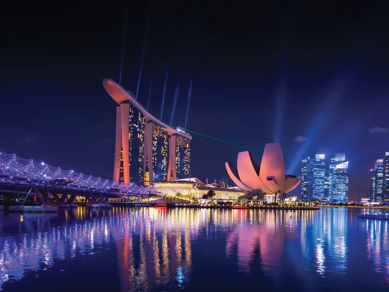 Marina Bay Sands lit at night with the ArtScience Museum beside it